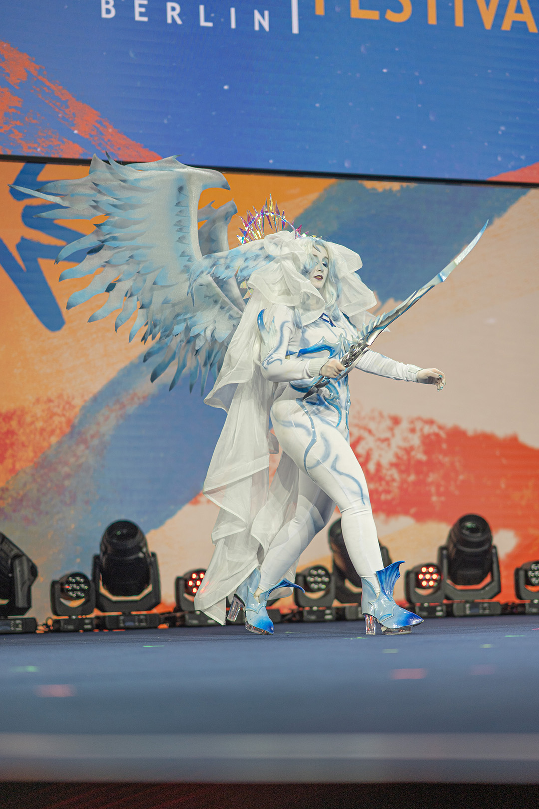 A player dressed as Hydaelyn on stage for the Glamoured to Life cosplay walk at Fan Festival 2026 in Berlin.