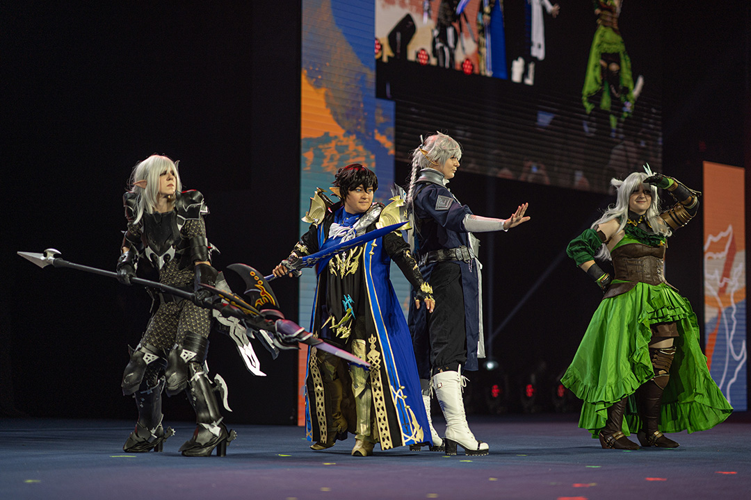 Four players on stage dressed a Estinien, Aymeric, Alphinaud, and a Warrior of Light for the Glamoured to Life cosplay walk at Fan Festival 2026 in Berlin.