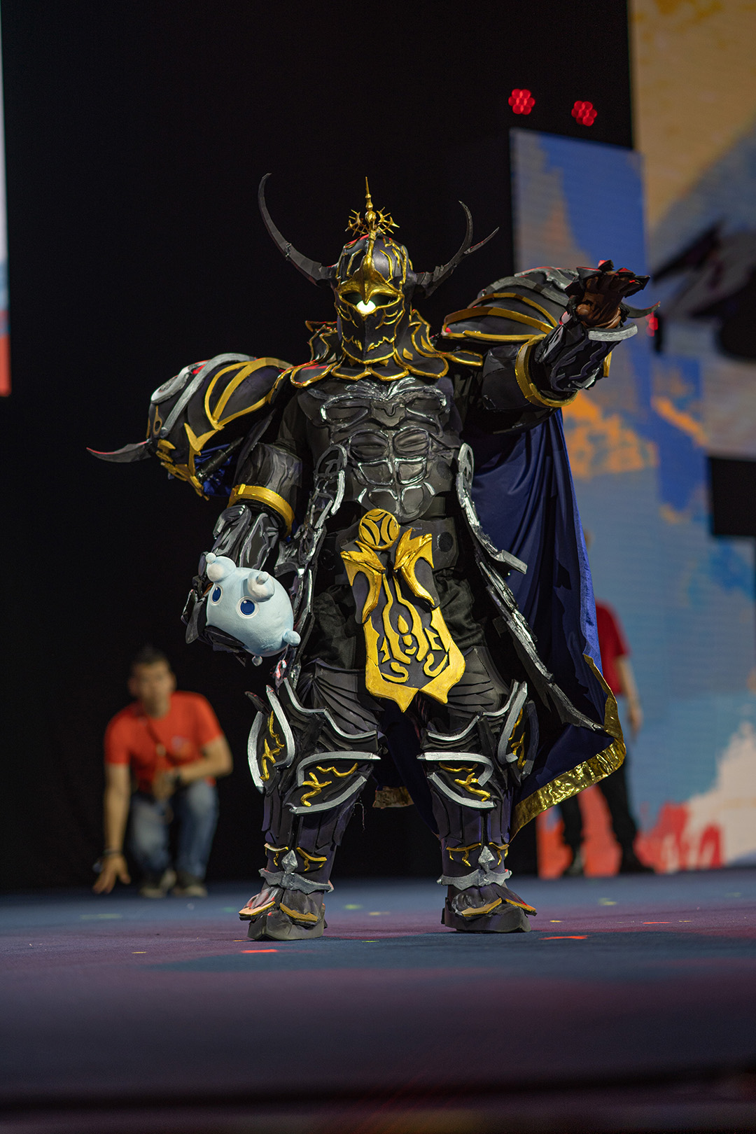 A player dressed as Golbez on stage for the Glamoured to Life cosplay walk at Fan Festival 2026 in Berlin.