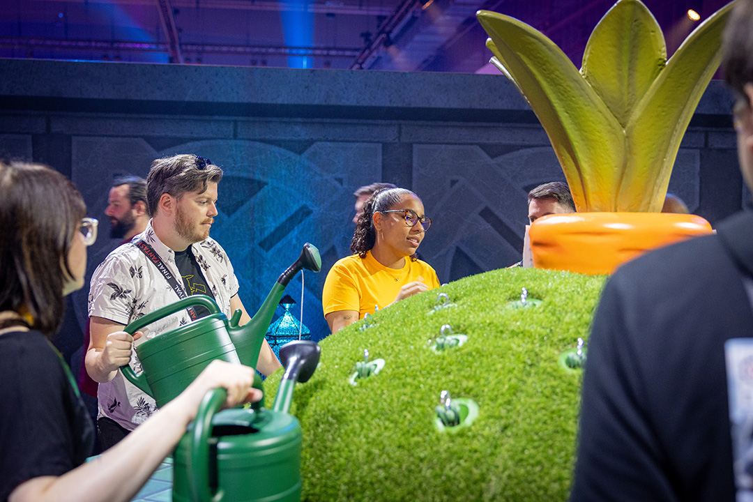 A photograph of Fan Festival 2026 in Berlin attendees engaging in a watering can minigame activity.