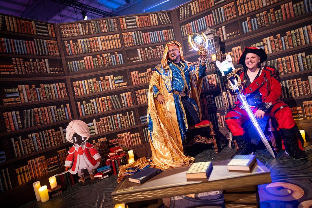 Fan Festival 2026 in Berlin attendees in cosplay posing in a Sharlayan-themed library area.