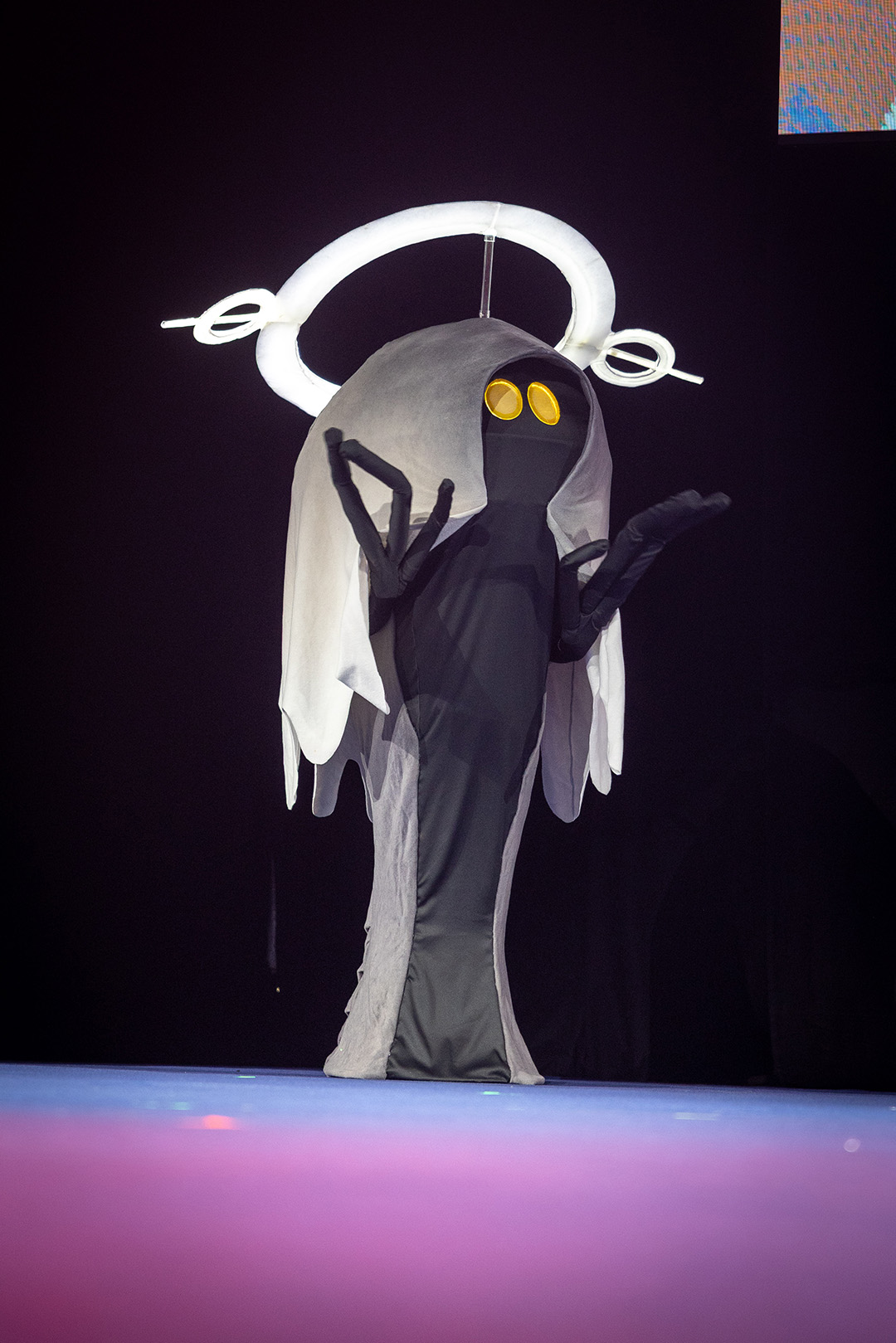 A player dressed as an Ea on stage for the Glamoured to Life cosplay walk at Fan Festival 2026 in Berlin.