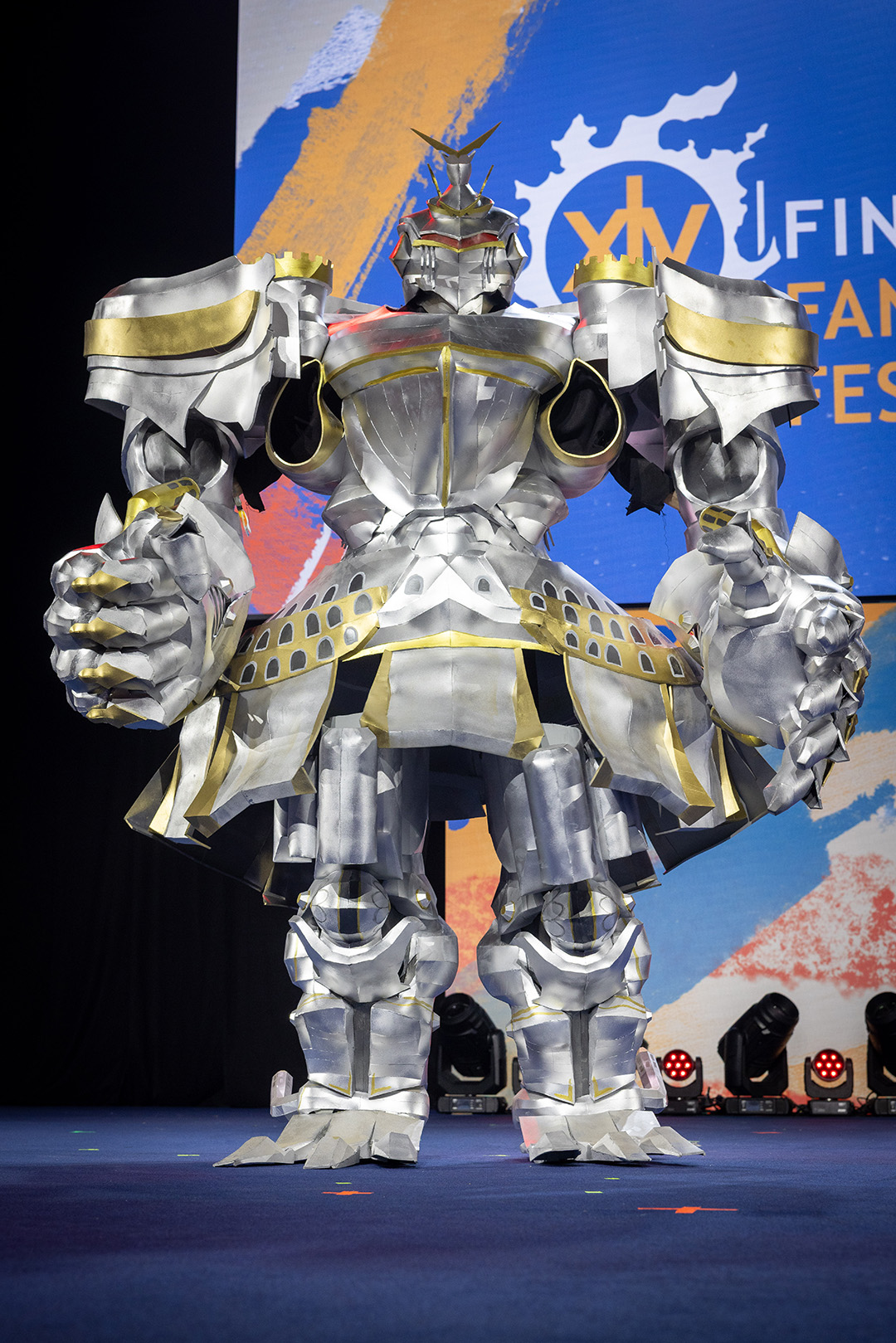 A player dressed as Perfect Alexander on stage for the Glamoured to Life cosplay walk at Fan Festival 2026 in Berlin.