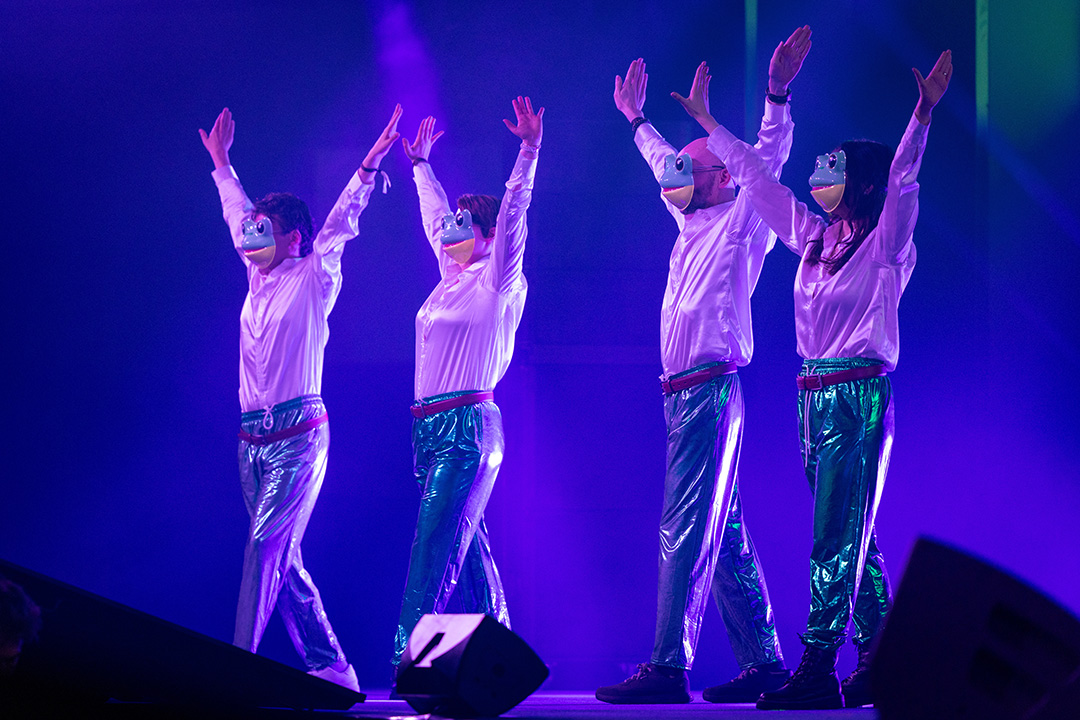 Four members of the Final Fantasy 14 Community team wearing frog masks and posing on stage at Fan Festival 2026 in Berlin.